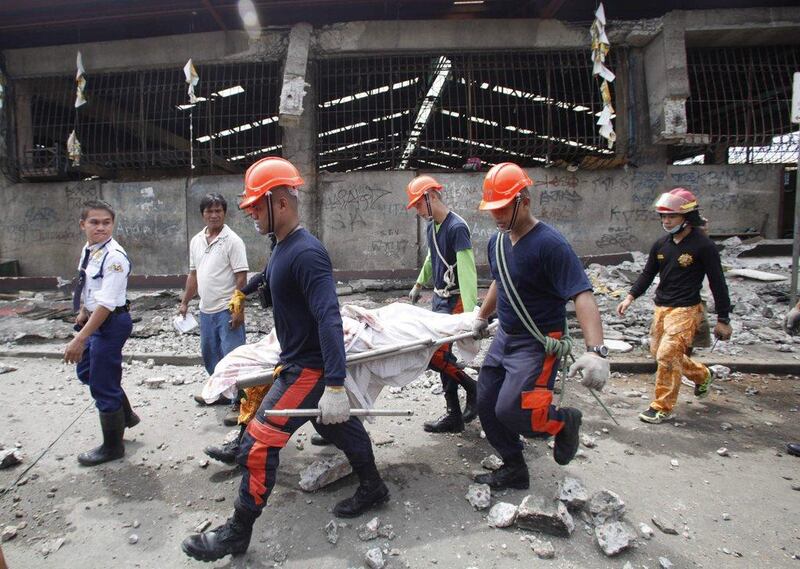  Rescue members recover the body of a vendor killed after an earthquake hit Pasil market in Cebu City, Central Philippines. Reuters / Stringer