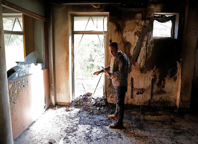 An Afghan journalist talks live inside a burnt room after yesterday's attack at the university of Kabul. Reuters