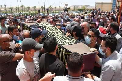 Egyptians carry the coffin of comedian actor Samir Ghanem during his funeral at Cairo's Field Marshal Hussein Tantawi mosque in the eastern outskirts of the Egyptian capital on May 21, 2021. The veteran Egyptian actor and comedian passed away on May 20, 2021, at the age of 84. / AFP / Mohamed EL-RAAI
