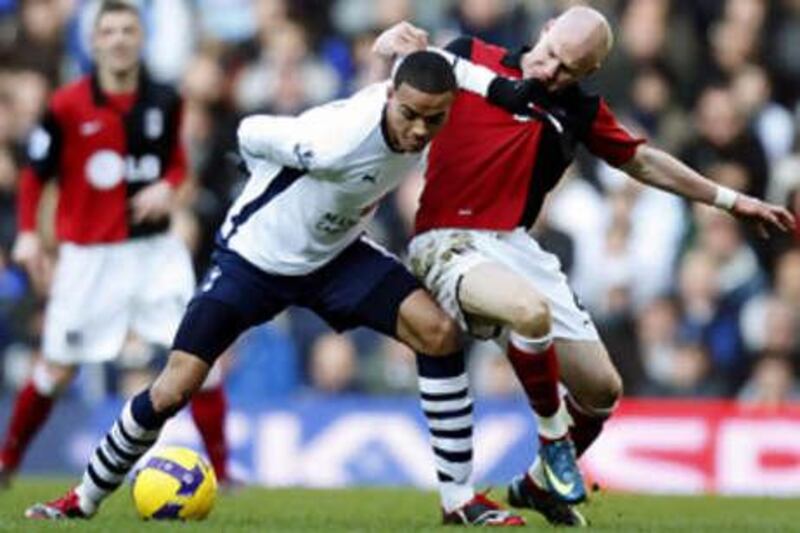 Fulham's Andrew Johnson, right, battles with the Spurs midfielder Jermaine Jenas.
