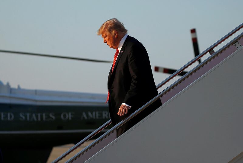 U.S. President Donald Trump waves as he walks from Air Force One as he arrives at Joint Base Andrews, Virginia, U.S., August 23, 2017.   REUTERS/Joshua Roberts