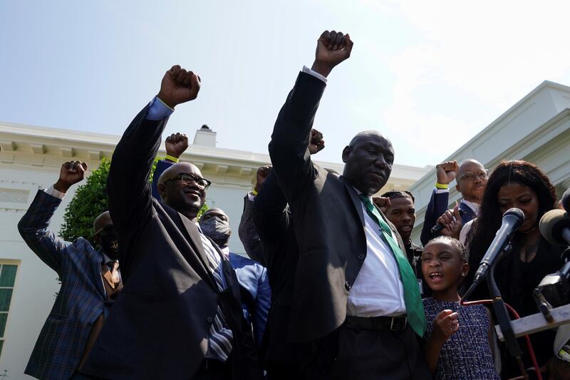 Gianna Floyd and other family members and lawyers, raise fists after meeting President Biden in Washington. Reuters