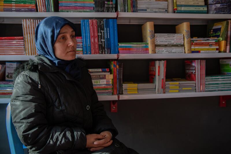 Wahida Shirzad, 38, sits in the small library that she set up after her son's death. Mohammad Rahid Amin was killed in an attack on Kabul University on 2 November 2020; a total of 22 students and teachers died that day. He leaves behind his mother, two sisters and a brother, as well as a father that Wahida has divorced long ago. 