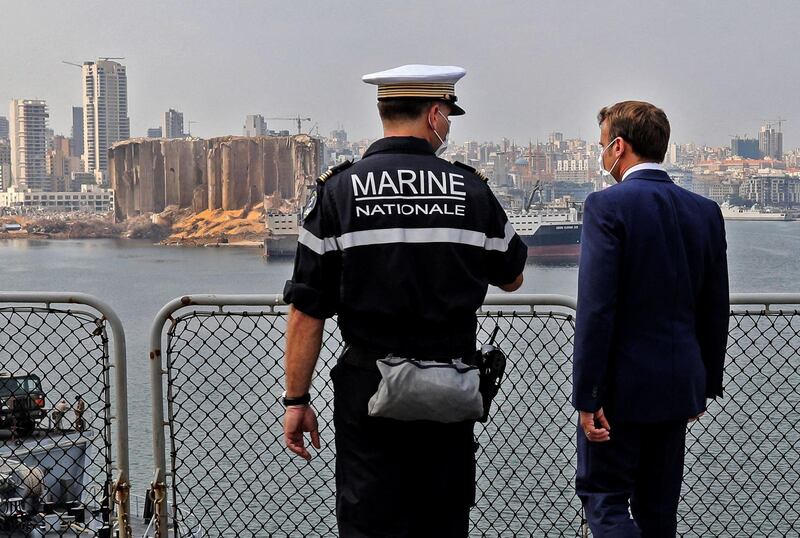 President Emmanuel Macron speak with speaks with Arnaud Tranchant, commander of the French helicopter carrier Tonnerre, off the port of Beirut on September 1, 2020. AFP