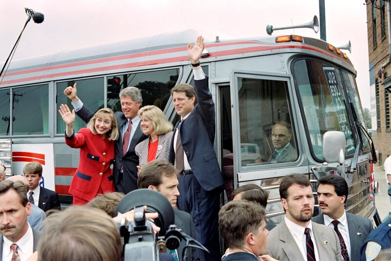 Democratic Presidential candidate Bill Clinton (2ndL) and running mate Al Gore (R), flanked by their wife Tipper Gore (2ndR) and Hillary Clinton (L), wave supporters before boarding their bus in Columbus on September 23, 1992. (Photo by Paul J. Richards / AFP)
