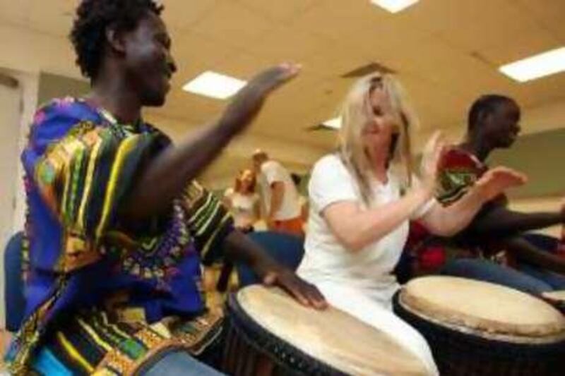 DUBAI, UAE, June 22, 2008; (Left-right) Atsu Dugadu, Julie Ann Odell and Abdulah Dugadu enjoy playing the drum during their weekly drum circle at the Dubai Community Theater in the Mall of the Emirates. Paulo Vecina/The National  *** Local Caption ***  PV Drum 17.JPG