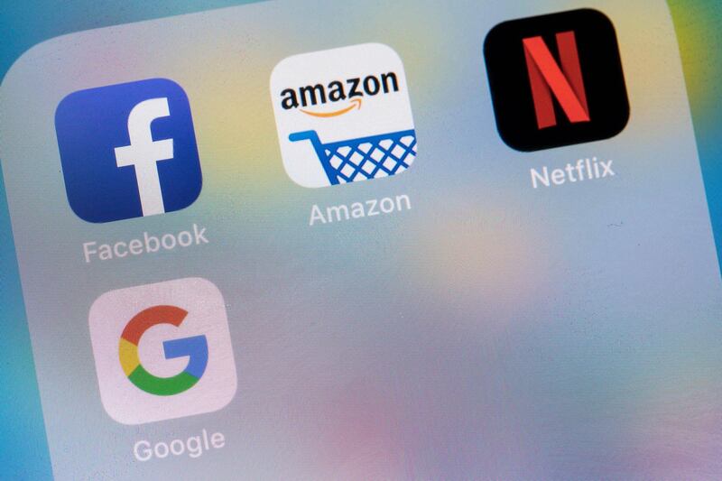 Icons for the Facebook Inc. app, the Amazon.com Inc. app, the Netflix Inc. app and the Google, a unit of Alphabet Inc., app sit on a Apple Inc. iPhone smartphone in this arranged photograph in London, U.K., on Monday, Aug. 20, 2018. The NYSE FANG+ Index is an equal-dollar weighted index designed to represent a segment of the technology and consumer discretionary sectors consisting of highly-traded growth stocks of technology and tech-enabled companies. Photographer: Jason Alden/Bloomberg
