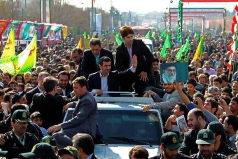 Iranian president Mahmoud Ahmadinejad (centre) greets supporters during a rally in Tehran's Azadi Square to mark the 34th anniversary of the Islamic revolution on February 10.