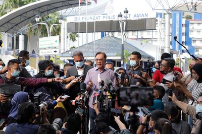 Malaysia opposition leader Anwar Ibrahim speaks to media members after being questioned by the Malaysian police over an investigation of a viral list of 121 federal lawmakers, allegedly backing his bid to take over the premiership from Muhyiddin Yassin, outside Bukit Aman police headquarters, in Kuala Lumpur, Malaysia October 16, 2020. REUTERS/Lim Huey Teng
