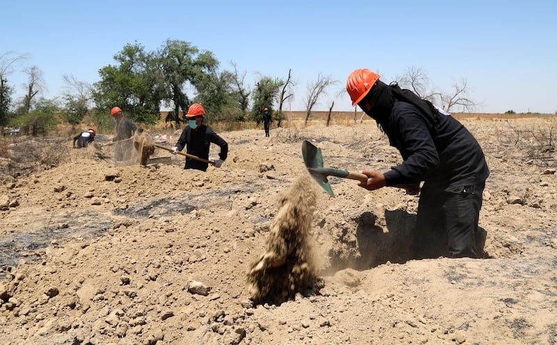 A Syrian forensic team works at a site believed to be a mass grave, in Raqqa city, northeastern Syria. EPA