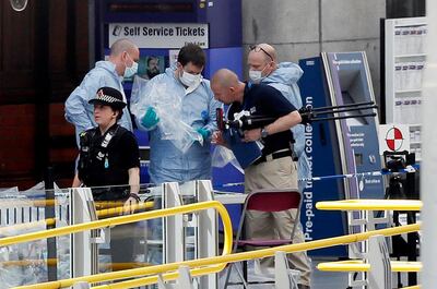 Forensic officers investigate the scene near the Manchester Arena, Manchester, England, Tuesday May 23, 2017, the day after the suicide attack at an Ariana Grande concert that left 22 people dead as it ended on Monday night. (AP Photo/Kirsty Wigglesworth)