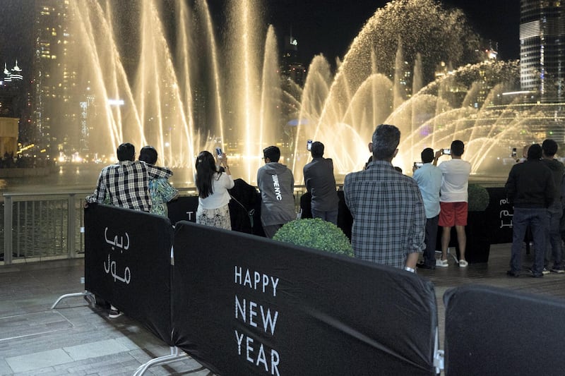 Dubai, United Arab Emirates, December 31, 2017:    Revellers watch the Dubai Mall fountain ahead of New Years Eve celebrations on in the downtown area of Dubai on December 31, 2017. Christopher Pike / The National

Reporter:  N/A
Section: News