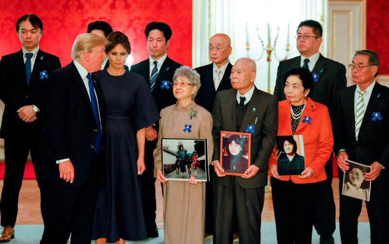 US President Donald Trump and First Lady Melania meets families of abductees by North Korea in Tokyo on November 6, 2017.
Trump met Sakie Yokota (front row C), 81, mother of Megumi Yokota who was abducted by North Korean agents in Japan when she was a 13-year-old junior high school student, and Megumi's twin brothers Takuya and Tetsuya Yokota (Left behind of Sakie).  / AFP PHOTO / POOL / Kimimasa MAYAMA
