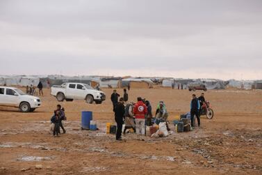 Aid workers of the Syrian Arab Red Crescent deliver aid in the Rukban camp for displaced Syrians in November 2018. SARC