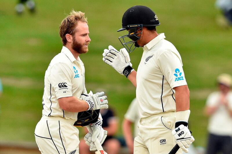 New Zealand's captain Kane Williamson (L) celebrates reaching his century (100 runs) with a teammate Ross Taylor during the fifth day of the second cricket Test match between England and New Zealand at Seddon Park in Hamilton on December 3, 2019. / AFP / Peter PARKS                        
