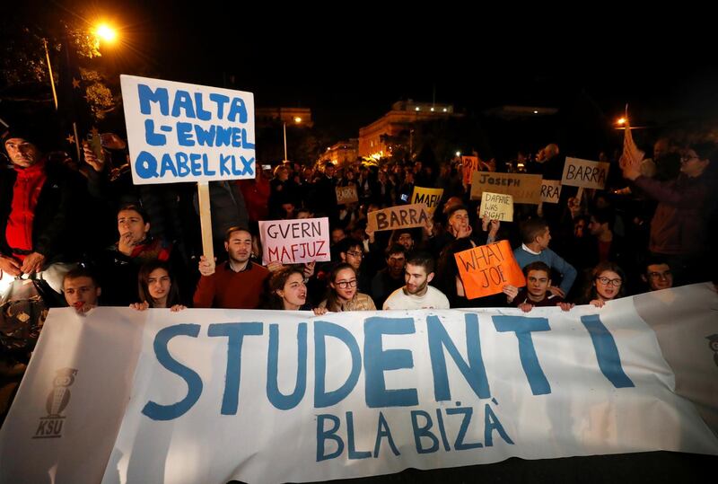 Students hold signs and a banner outside the Government Palace following the resignation of government ministers. Reuters