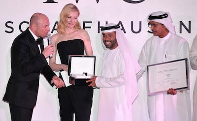 DUBAI, UNITED ARAB EMIRATES - DECEMBER 07:  Waleed Al Shehhi is presented with his award by Georges Kern (L), Cate Blanchett and DIFF Chairman Abdulhamid Juma on stage at "For The Love of Cinema - IWC Filmmakers Award" during day two of the 10th Annual Dubai International Film Festival held at the One and Only Mirage Hotel on December 7, 2013 in Dubai, United Arab Emirates.  (Photo by Gareth Cattermole/Getty Images for DIFF) *** Local Caption *** Georges Kern; Cate Blanchett; Waleed Al Shehhi; Abdulhamid Juma