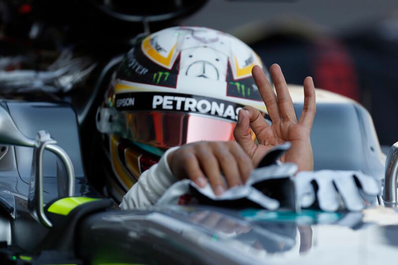 Mercedes driver Lewis Hamilton, of Britain, gestures to fans in the pit lane during the first practice session, prior to Sunday's Mexico Grand Prix, at the Hermanos Rodriguez racetrack in Mexico City, Friday, Oct. 27, 2017. (AP Photo/Moises Castillo)