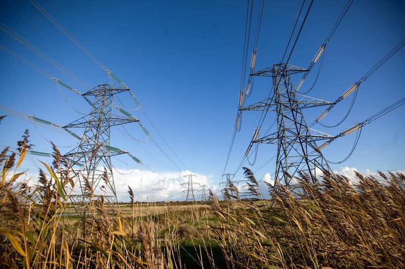 Electricity transmission pylons near Dungeness Power station, operated by Electricite de France SA (EDF), in Dungeness, U.K., on Monday, Oct. 26, 2020. The U.K.'s power supply buffer is set to shrink this winter compared to last year due to outages at power plants and the unexpected closure of two of Calon Energy Ltd.'s gas-fired stations after the company went into administration. Photographer: Chris Ratcliffe/Bloomberg