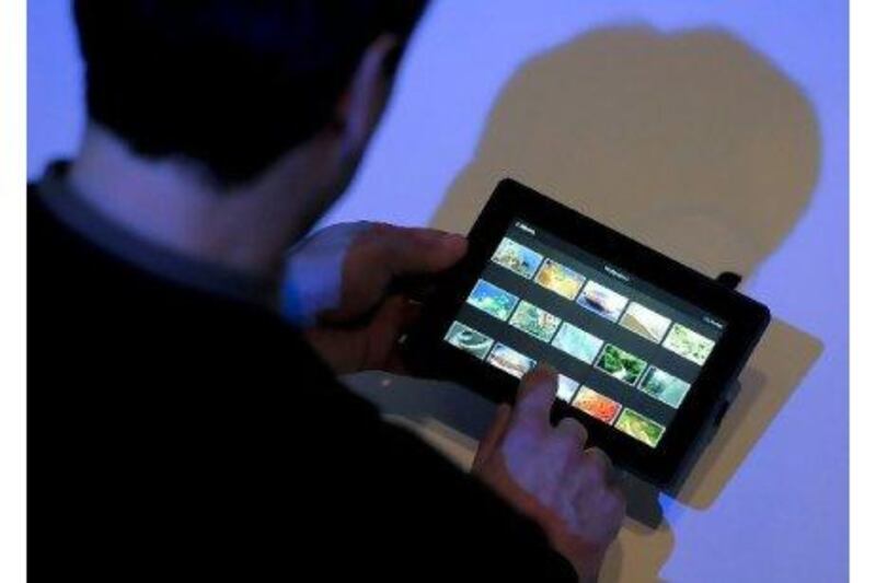 A visitor test-drives the new BlackBerry Playbook at the 3GSM world congress in Barcelona, Spain in February.