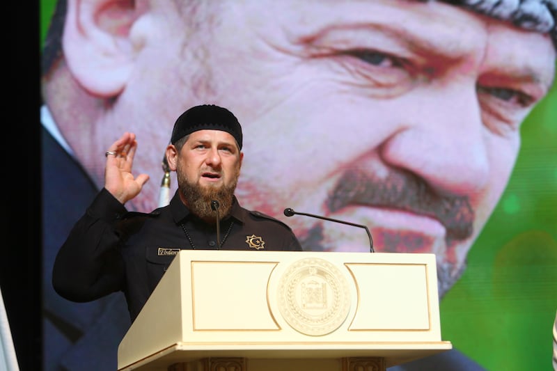 Chechnya's regional leader Ramzan Kadyrov speaks in front of a portrait of his father Akhmad Kadyrov, the Chechen president who was assassinated in a 2004 bomb blast, at a meeting in Chechnya's provincial capital Grozny, Russia, Tuesday, Aug. 22, 2017. (AP Photo/Musa Sadulayev)