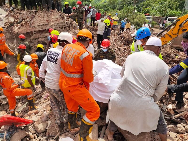epa08624245 A handout photo made available by the National Disaster Response Force (NDRF) shows members of the NDRF during a rescue operation at the site of a building collapse in Raigad, Maharashtra, India, 25 August 2020. According to media reports, five people were killed in the collapse.  EPA/NATIONAL DISASTER RESPONSE FORCE HANDOUT  HANDOUT EDITORIAL USE ONLY/NO SALES