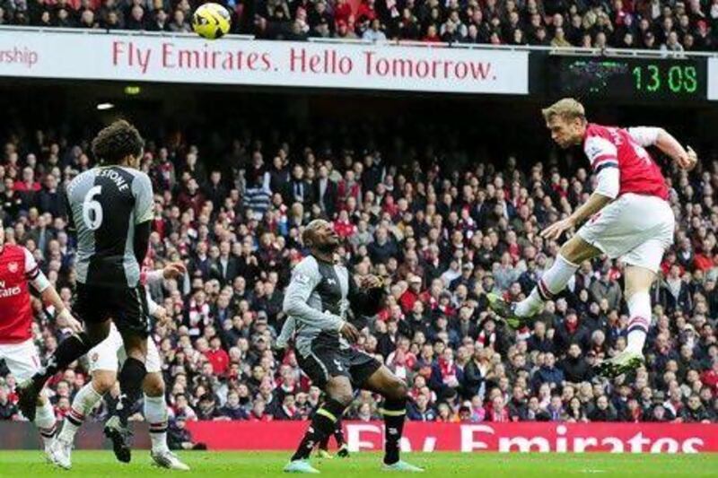 Per Mertesacker scores Arsenal's first goal that brought the home team back into the game before thrashing Tottenham Hotspur.