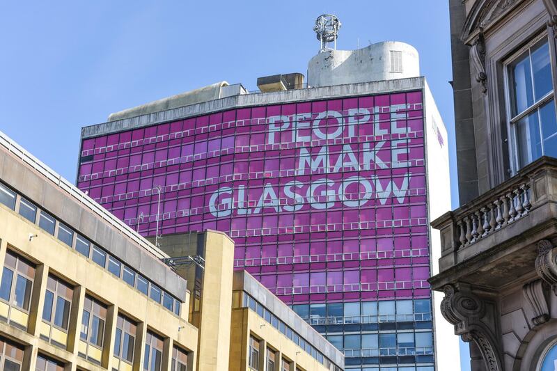 Glasgow College of Building and Printing covered in a 'People Make Glasgow' building wrap. The slogan is the brand slogan of the City of Glasgow and the building was decorated in advance of the 2014 Commonwealth Games.