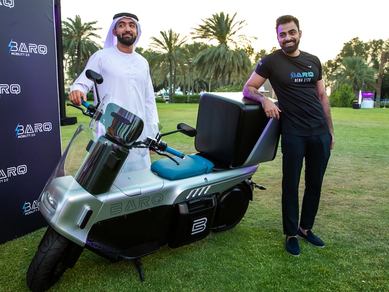 Co-founders of Barq, Ahmed Al Mazroui, left, and Abdallah Abu Sheikh with the Rena Max electric moped. Victor Besa / The National