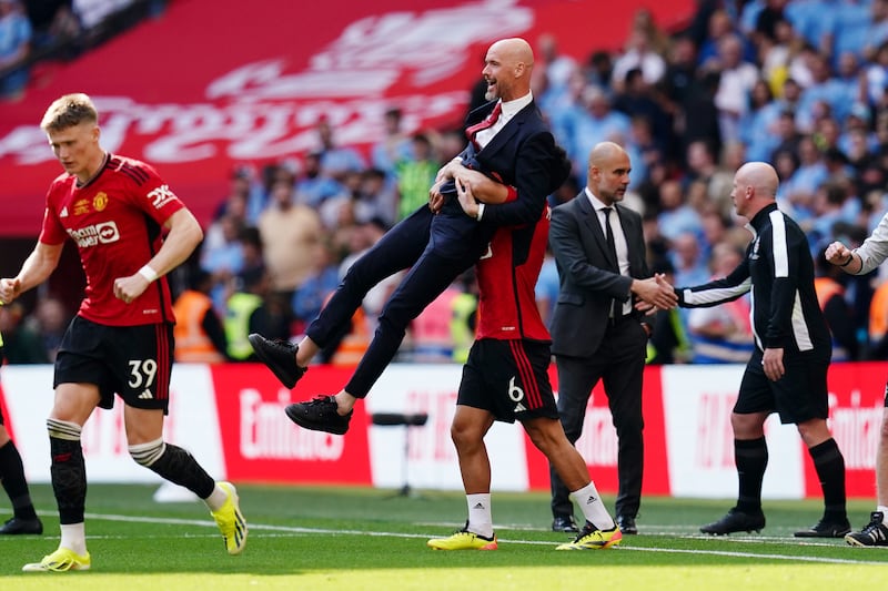 Manchester United manager Erik ten Hag celebrates with Lisandro Martinez after winning the Emirates FA Cup. PA