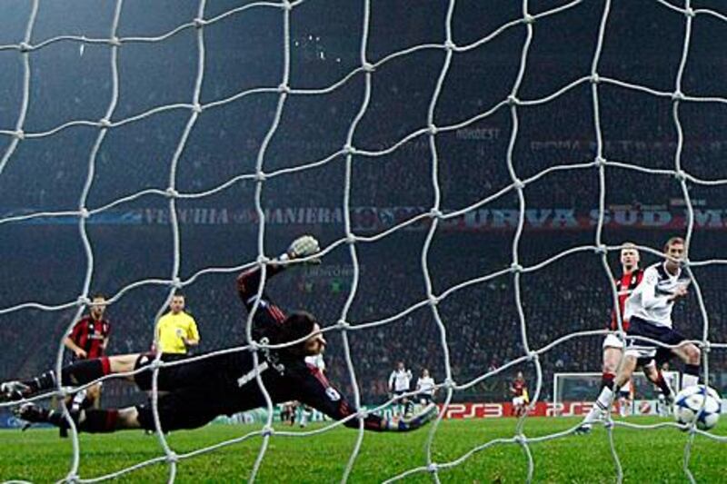 Tottenham Hotspur's Peter Crouch scores past AC Milan goalkeeper Marco Amelia.