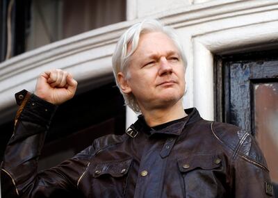FILE - In this May 19, 2017 file photo, WikiLeaks founder Julian Assange greets supporters outside the Ecuadorian embassy in London, where he has been in self imposed exile since 2012. (AP Photo/Frank Augstein, File)