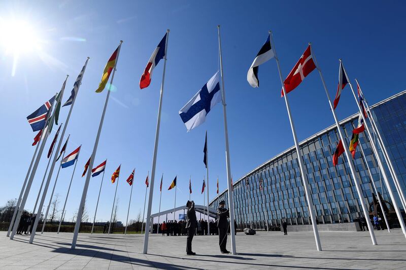 The Finnish flag is raised to join those of other Nato member states in Brussels on Tuesday. AFP