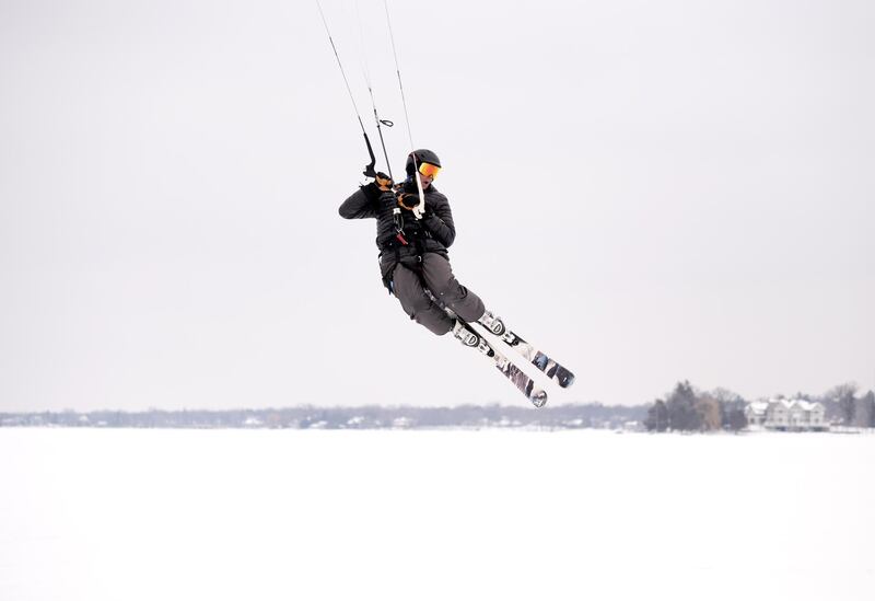 Mike Kratochwill flies through the air while snowkiting on Lake Minnetonka. AFP