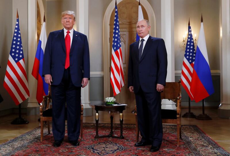 Donald Trump and Vladimir Putin stand aside one another in Helsinki. Reuters