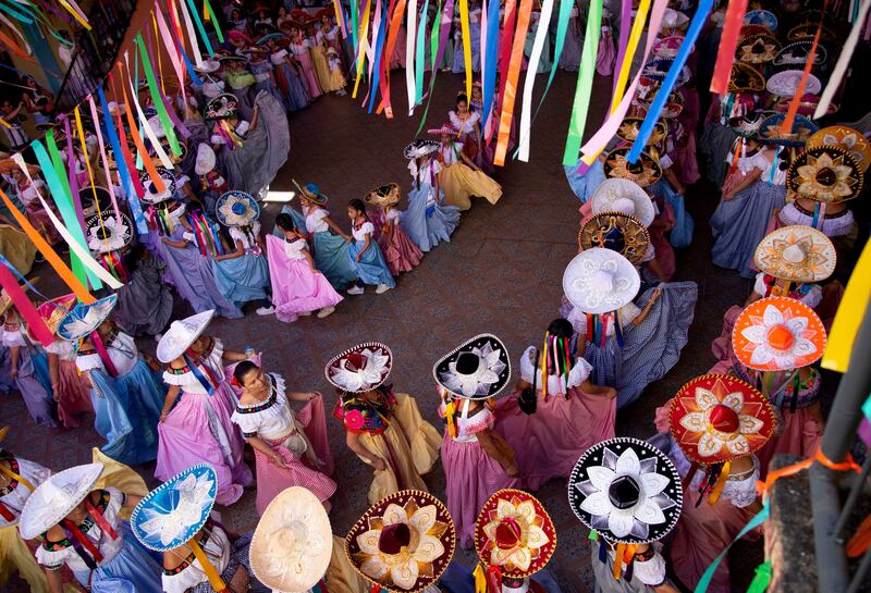 Women in traditional dress dance to celebrate El Dia de la Candelaria, or Candelaria Day, in San Fernando, Chiapas, Mexico. The women are dressed in zoque dresses and charro hats for a three-day celebration involving dance to drums and reed flutes. EPA