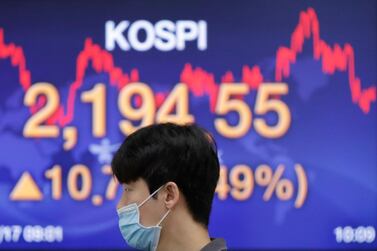The rebound in Asian markets has been helped by a perception that governments in the region have done a better job in containing the virus. Associated Press A currency trader walks by a screen at the foreign exchange dealing room in Seoul, South Korea. Share prices crashed in March by up to a third before recovering again amid stimulus measures. Associated Press