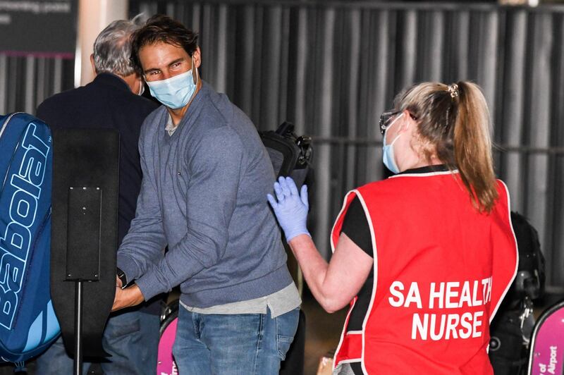 Rafael Nadal speaks to a nurse as he arrives in Australia. AFP