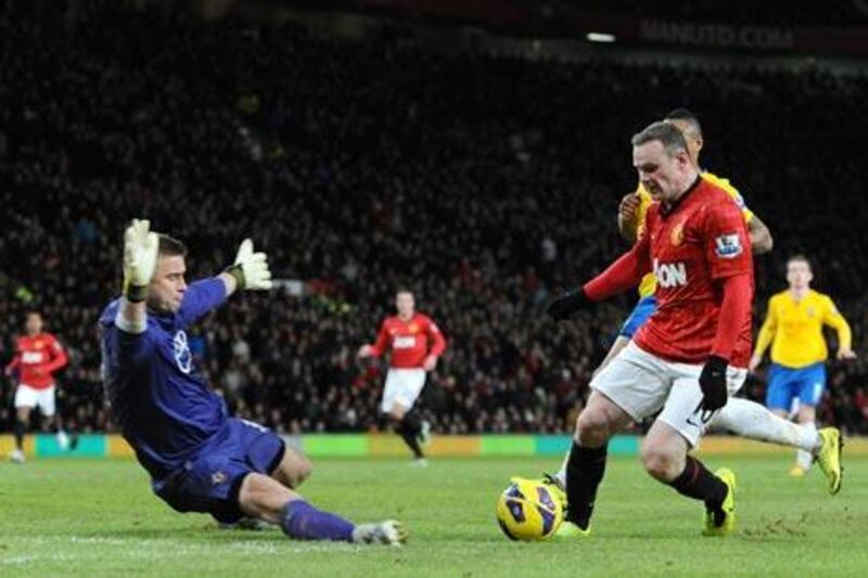 Manchester United's Wayne Rooney, right, has a shot saved by Southampton's goalkeeper Artur Boruc. Ptere Powell / EPA