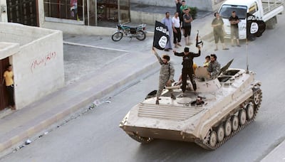 Militant Islamist fighters take part in a military parade along the streets of northern Raqqa province. Reuters