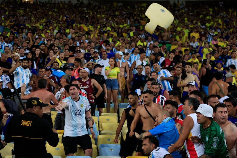 A stand seat is thrown at police officers as tempers boil over inside Maracana Stadium. Getty Images