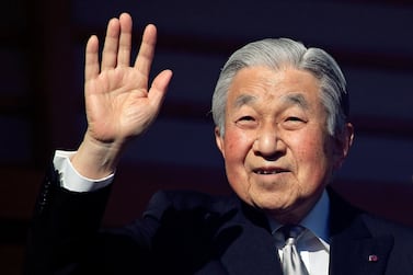 Japan's Emperor Akihito waves to well-wishers through bullet-proof glass during his New Year's public appearance at the Imperial Palace in central Tokyo, Japan. EPA