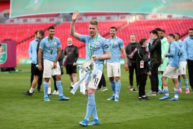 Manchester City's Belgian midfielder Kevin De Bruyne holds the winners trophy after the English League Cup final football match between Manchester City and Tottenham Hotspur at Wembley Stadium, northwest London on April 25, 2021. Manchester City claimed a fourth consecutive League Cup on Sunday with a dominant display to beat Tottenham 1-0 in front of 8,000 fans at Wembley. - RESTRICTED TO EDITORIAL USE. No use with unauthorized audio, video, data, fixture lists, club/league logos or 'live' services. Online in-match use limited to 120 images. An additional 40 images may be used in extra time. No video emulation. Social media in-match use limited to 120 images. An additional 40 images may be used in extra time. No use in betting publications, games or single club/league/player publications. / AFP / POOL / CARL RECINE / RESTRICTED TO EDITORIAL USE. No use with unauthorized audio, video, data, fixture lists, club/league logos or 'live' services. Online in-match use limited to 120 images. An additional 40 images may be used in extra time. No video emulation. Social media in-match use limited to 120 images. An additional 40 images may be used in extra time. No use in betting publications, games or single club/league/player publications.