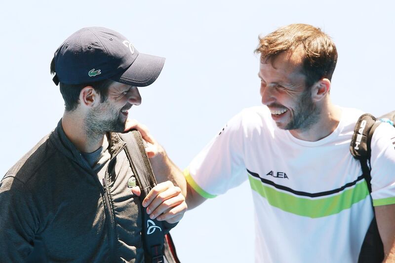 MELBOURNE, AUSTRALIA - JANUARY 09:  Novak Djokovic of Serbia, making a comeback from an elbow injury, is seen with Radek Stepanek of the Czech Republic (R) after a practice session ahead of the 2018 Australian Open at Melbourne Park on January 9, 2018 in Melbourne, Australia.  (Photo by Michael Dodge/Getty Images)