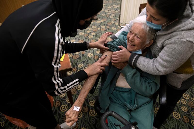 A woman receives a fourth dose of the coronavirus vaccine at a nursing home in Tel Mond, Israel. Getty Images