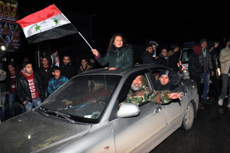 Syrians celebrate on December 22, 2016 in the northern Syrian city of Aleppo, after the army said it has retaken full control of the country's second city The army said it has retaken full control of Syria's devastated second city Aleppo, scoring its biggest victory against opposition forces since the civil war erupted in 2011.  George Ourfalian / AFP 


