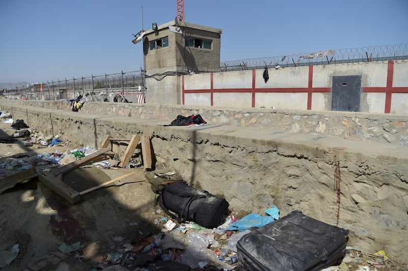 Luggage belonging to Afghan people, who were waiting to be evacuated. at the site of two suicide bombs, which killed scores of people including 13 US troops, at Kabul airport on August 27, 2021. AFP