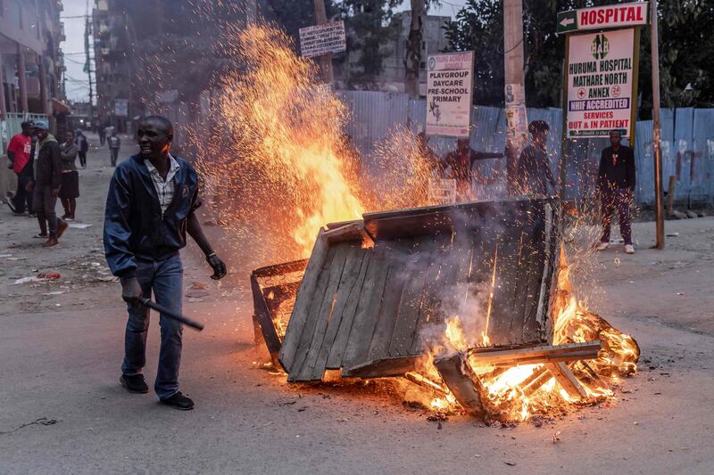 An Azimio La Umoja Party supporter protests in front of a burning barricade near in the informal settlement of Mathare in Nairobi. AFP