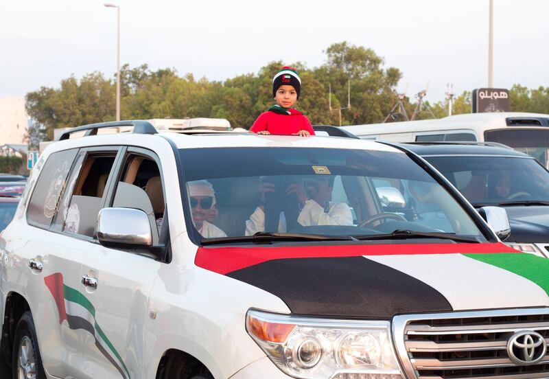 Abu Dhabi, United Arab Emirates - People parade their vehicles with UAE stickers on their car at Abu Dhabi Corniche, Breakwater.  Leslie Pableo for The National