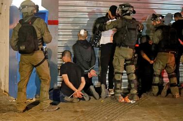 Israeli forces detain a group of Palestinian Israelis in the mixed Arab-Jewish city of Lod on May 13, 2021, during clashes between Jewish far-right extremists and Arab residents. AFP